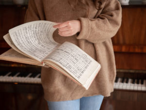 Close-up of musical notes in female hands.
