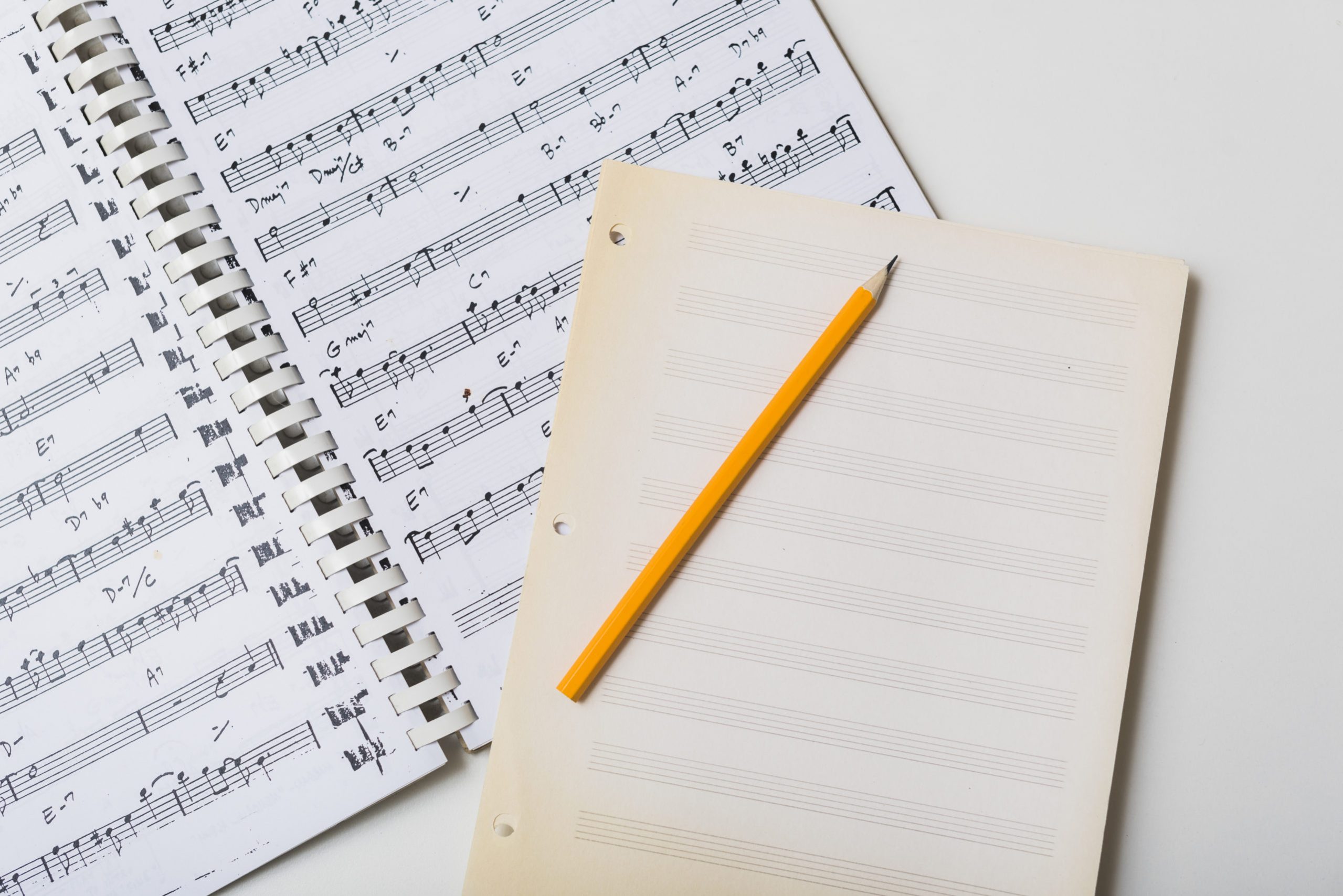 pencil-and-mpty-pages-on-sheet-music